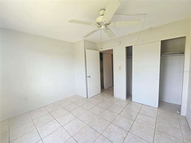 2321 Canal Dr Unit F25, Bradenton, FL 34207 - unfurnished bedroom featuring light tile patterned floors, a closet, and a ceiling fan