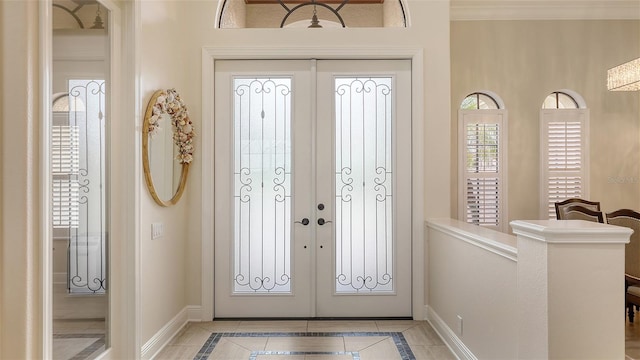 6919 Dominion Ln, Lakewood Ranch, FL 34202 - foyer entrance featuring french doors, inlaid floor details, and light tile patterned flooring