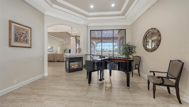 6919 Dominion Ln, Lakewood Ranch, FL 34202 - living area featuring crown molding, arched walkways, a raised ceiling, and recessed lighting