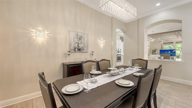 6919 Dominion Ln, Lakewood Ranch, FL 34202 - dining space featuring arched walkways, ornamental molding, wood finished floors, recessed lighting, and a chandelier