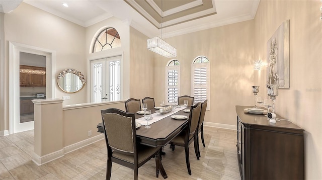 6919 Dominion Ln, Lakewood Ranch, FL 34202 - dining space featuring crown molding, french doors, a high ceiling, and light wood-style flooring