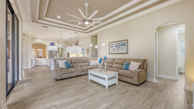6919 Dominion Ln, Lakewood Ranch, FL 34202 - living area featuring arched walkways, ceiling fan, ornamental molding, light wood-style floors, and recessed lighting