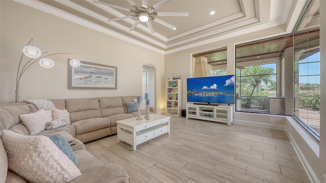 6919 Dominion Ln, Lakewood Ranch, FL 34202 - living room featuring arched walkways, ceiling fan, crown molding, a tray ceiling, and recessed lighting