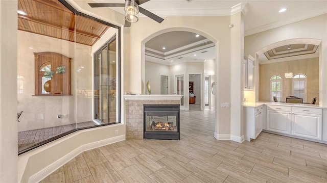 6919 Dominion Ln, Lakewood Ranch, FL 34202 - unfurnished living room with a ceiling fan, arched walkways, ornamental molding, a fireplace, and recessed lighting