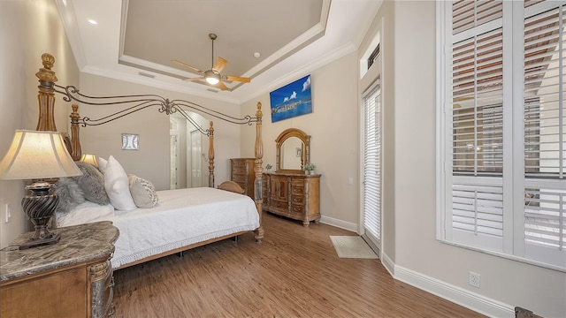 6919 Dominion Ln, Lakewood Ranch, FL 34202 - bedroom with a tray ceiling, ornamental molding, and wood finished floors