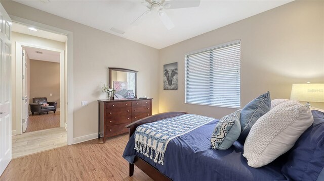 6919 Dominion Ln, Lakewood Ranch, FL 34202 - bedroom with light wood-style flooring, multiple windows, and a ceiling fan