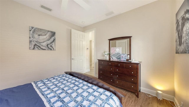 6919 Dominion Ln, Lakewood Ranch, FL 34202 - bedroom featuring baseboards and wood finished floors