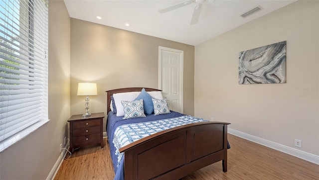 6919 Dominion Ln, Lakewood Ranch, FL 34202 - bedroom with multiple windows, light wood-type flooring, and ceiling fan