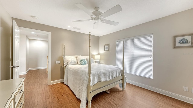 6919 Dominion Ln, Lakewood Ranch, FL 34202 - bedroom featuring light wood finished floors and a ceiling fan