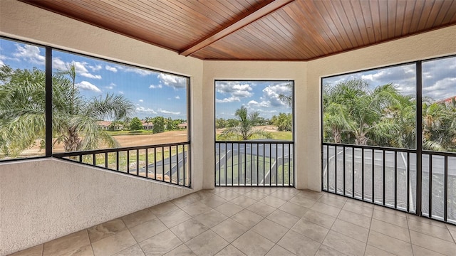 6919 Dominion Ln, Lakewood Ranch, FL 34202 - unfurnished sunroom with a textured wall, tile patterned flooring, wood ceiling, and plenty of natural light