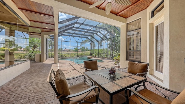 6919 Dominion Ln, Lakewood Ranch, FL 34202 - view of patio / terrace featuring a ceiling fan, a pool with connected hot tub, glass enclosure, and outdoor dining space