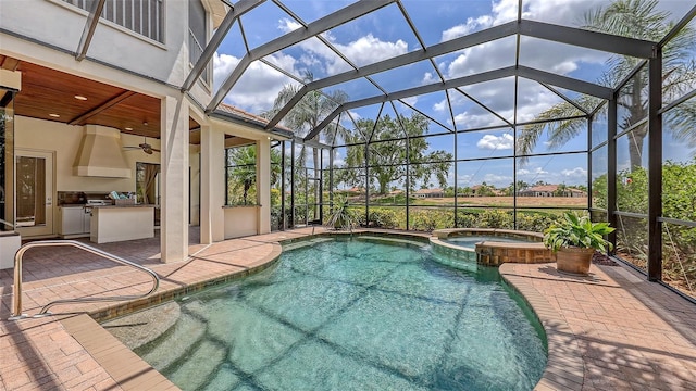 6919 Dominion Ln, Lakewood Ranch, FL 34202 - view of swimming pool with an outdoor kitchen, a patio area, glass enclosure, a pool with connected hot tub, and ceiling fan