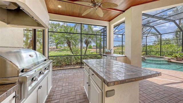 6919 Dominion Ln, Lakewood Ranch, FL 34202 - sunroom / solarium with an outdoor kitchen, a hot tub, and a ceiling fan