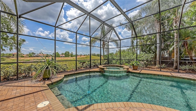 6919 Dominion Ln, Lakewood Ranch, FL 34202 - view of swimming pool with a pool with connected hot tub, glass enclosure, and a patio area