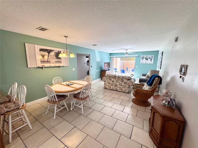 dining room featuring a textured ceiling, a chandelier, baseboards, light tile patterned floors, and visible vents