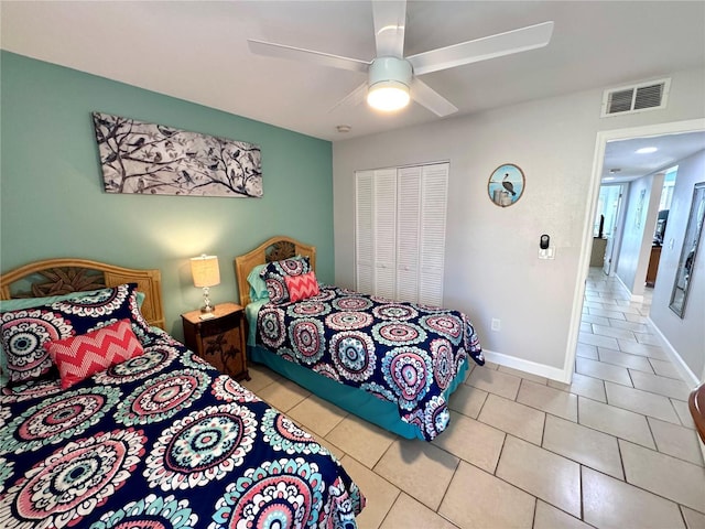 bedroom with baseboards, tile patterned floors, visible vents, and ceiling fan
