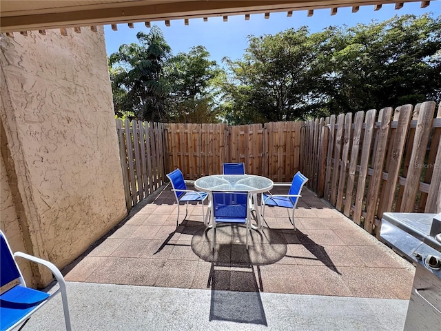 view of patio / terrace featuring fence and outdoor dining space