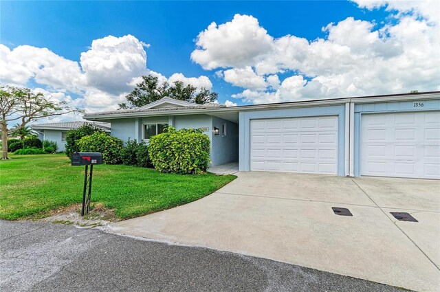 single story home with a garage, stucco siding, driveway, and a front yard