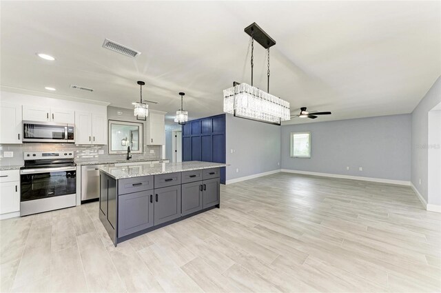 kitchen featuring visible vents, a ceiling fan, white cabinetry, and appliances with stainless steel finishes