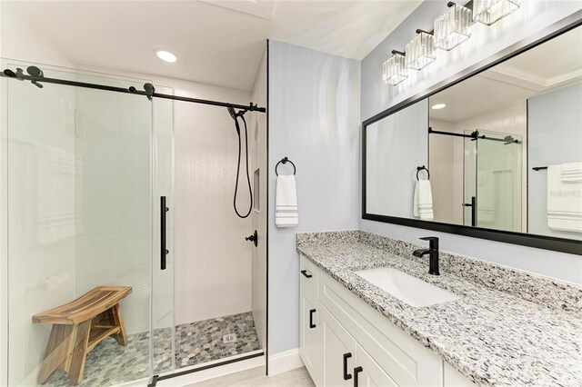 full bath featuring vanity, recessed lighting, baseboards, and a stall shower