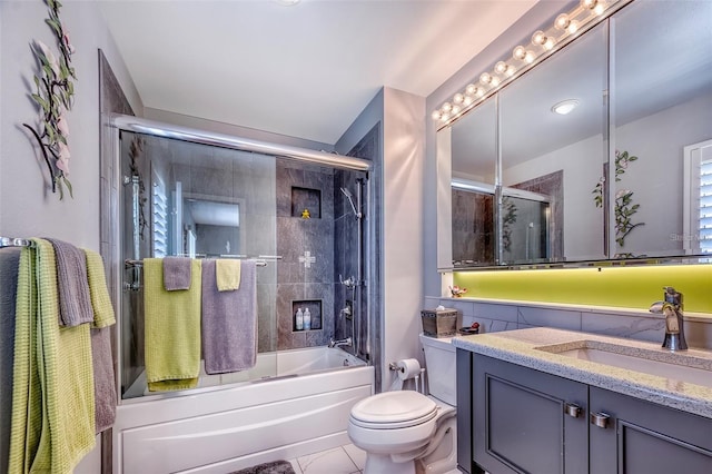bathroom with vanity, enclosed tub / shower combo, toilet, and tile patterned flooring