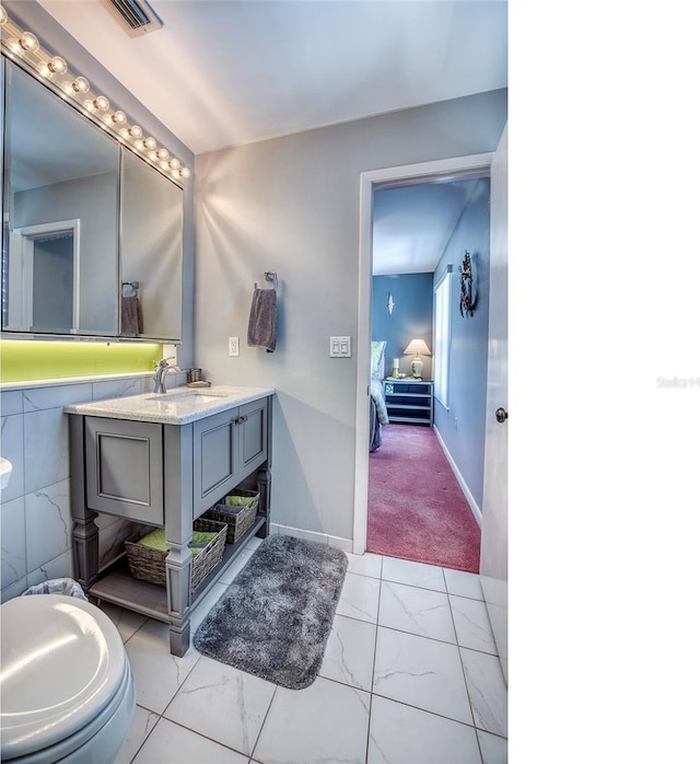bathroom featuring visible vents, marble finish floor, and vanity