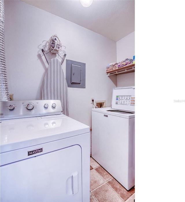 laundry room with laundry area, separate washer and dryer, and electric panel