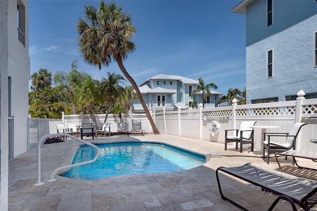 view of swimming pool with a fenced in pool, fence, and a patio