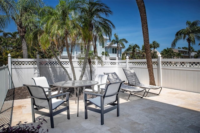 view of patio with outdoor dining area and a fenced backyard