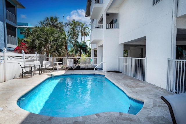 view of pool with fence, a fenced in pool, and a patio