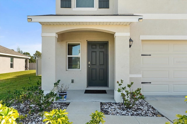 6314 Distant Haze Pl, Palmetto, FL 34221 - entrance to property with stucco siding, an attached garage, and a lawn