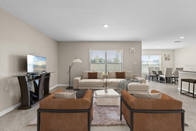 6314 Distant Haze Pl, Palmetto, FL 34221 - living room featuring baseboards, light tile patterned flooring, a textured ceiling, and recessed lighting