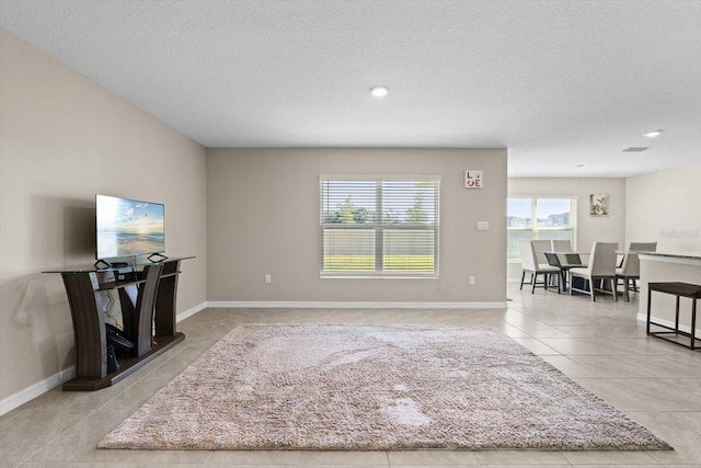 6314 Distant Haze Pl, Palmetto, FL 34221 - tiled living area with baseboards, a textured ceiling, and recessed lighting