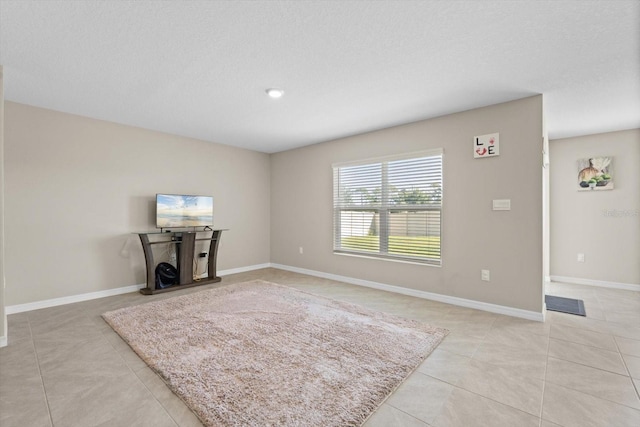 6314 Distant Haze Pl, Palmetto, FL 34221 - unfurnished living room featuring light tile patterned floors, baseboards, and a textured ceiling