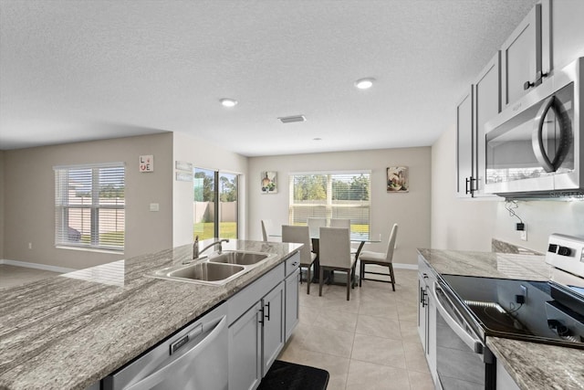 6314 Distant Haze Pl, Palmetto, FL 34221 - kitchen with appliances with stainless steel finishes, a sink, plenty of natural light, light tile patterned floors, and recessed lighting