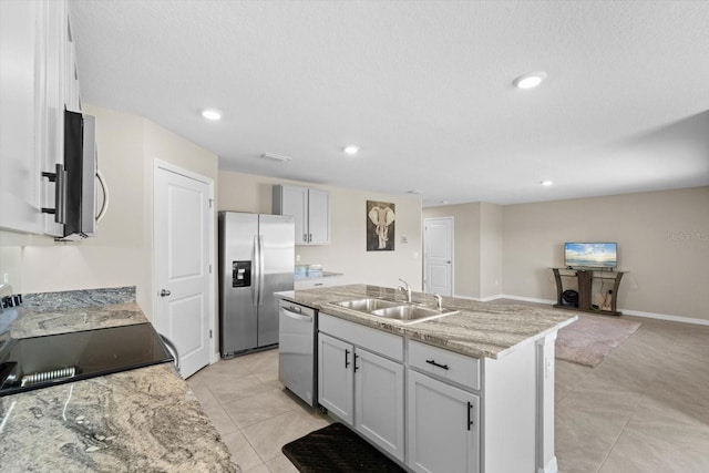 6314 Distant Haze Pl, Palmetto, FL 34221 - kitchen featuring appliances with stainless steel finishes, a sink, an island with sink, recessed lighting, and light tile patterned floors