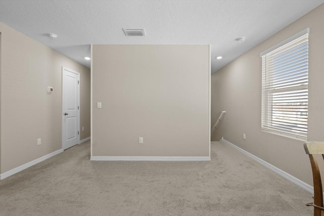 6314 Distant Haze Pl, Palmetto, FL 34221 - unfurnished room featuring light colored carpet, baseboards, a smoke detector, a textured ceiling, and recessed lighting
