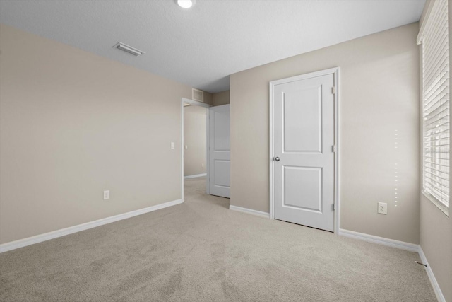 6314 Distant Haze Pl, Palmetto, FL 34221 - unfurnished bedroom with light colored carpet, baseboards, and multiple windows