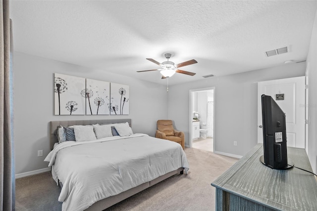 bedroom featuring connected bathroom, light colored carpet, a ceiling fan, baseboards, and visible vents