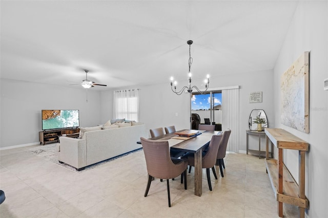 dining space with baseboards and ceiling fan with notable chandelier