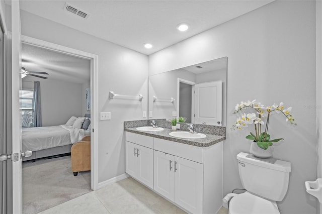 bathroom featuring connected bathroom, toilet, visible vents, and a sink