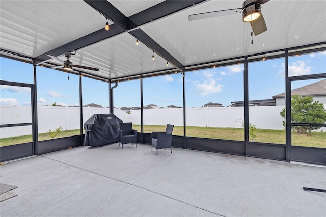 sunroom / solarium with a ceiling fan