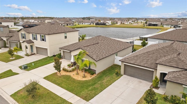 birds eye view of property featuring a water view and a residential view
