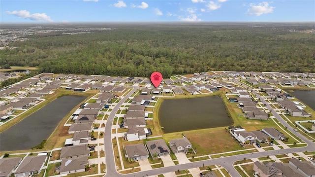 bird's eye view featuring a residential view and a wooded view