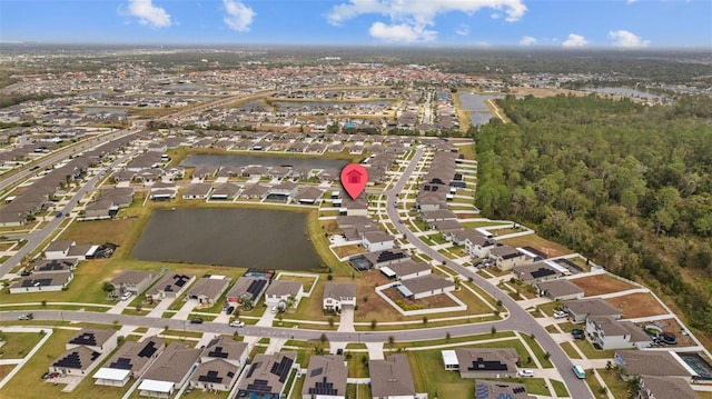 drone / aerial view with a water view and a residential view