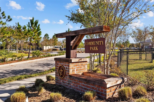 community / neighborhood sign with fence