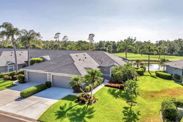 birds eye view of property with view of golf course and a water view