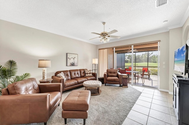 living area with visible vents, crown molding, a textured ceiling, and ceiling fan