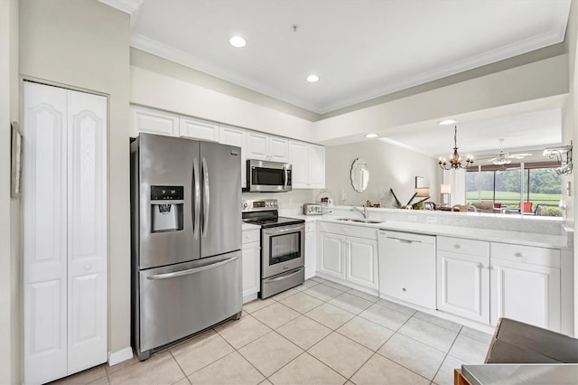 kitchen featuring crown molding, light tile patterned flooring, appliances with stainless steel finishes, and light countertops
