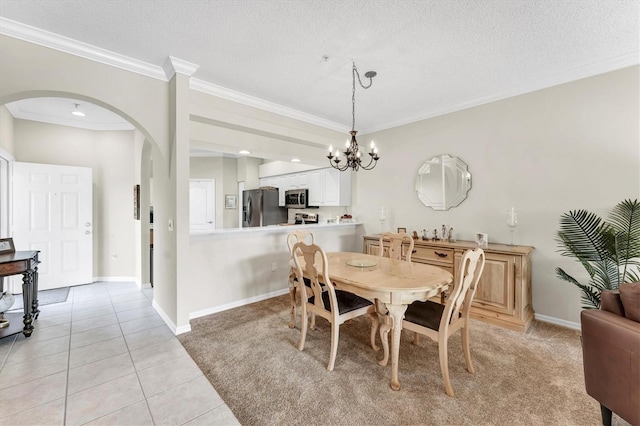 dining space with crown molding, an inviting chandelier, arched walkways, a textured ceiling, and light tile patterned floors
